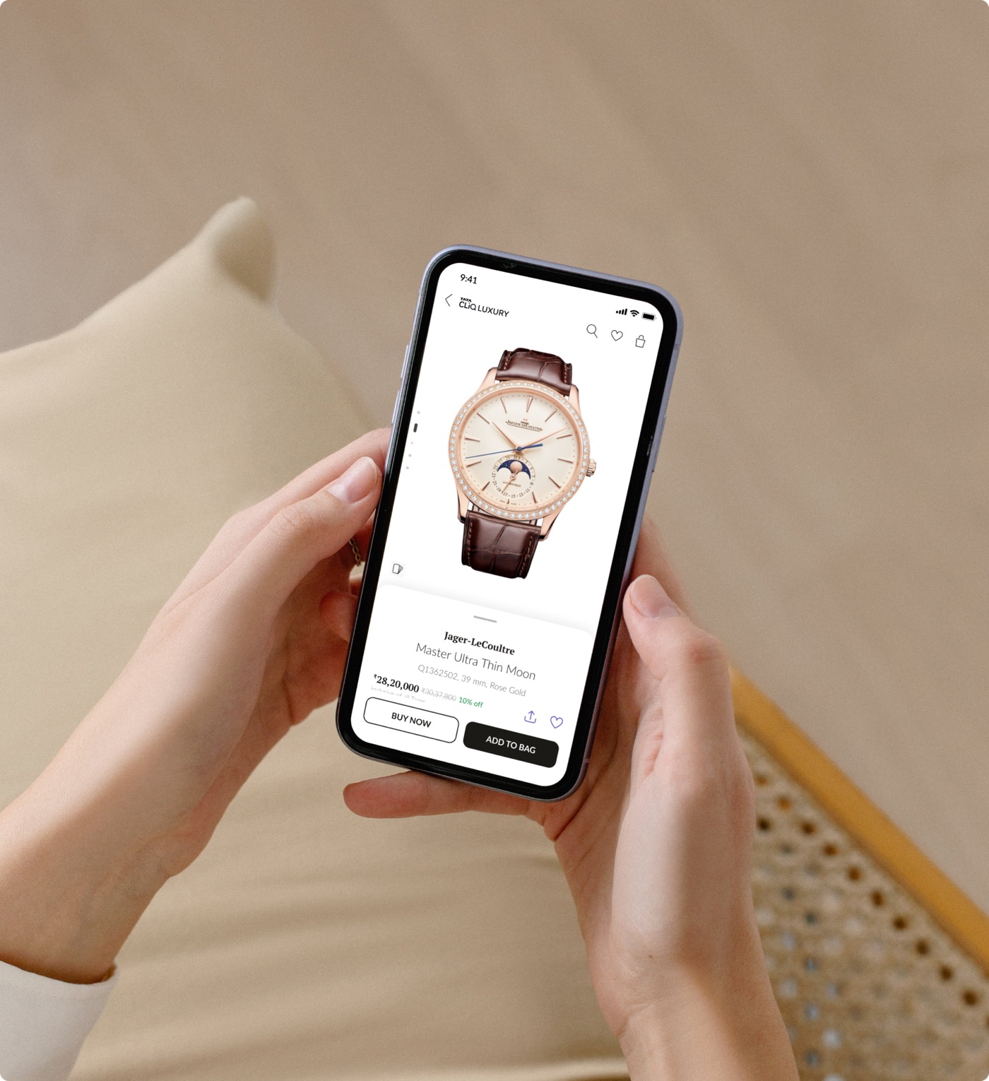 Hands holding a phone showing a redesigned luxury watch product page
